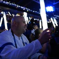 Brian Adkins holds a light up stick at a UK game.