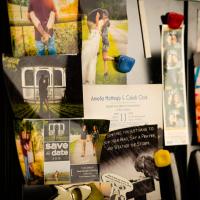Close up of a refrigerator door covered in wedding photos and baby photos of Cason.
