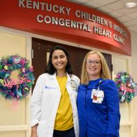 Dr. Ramachandran and Jennifer smile as they stand together in front of Kentucky Children’s Hospital’s Congenital Heart Clinic.