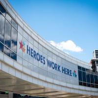 An oblique view of the UK HealthCare pedway across Limestone Street, which features a large sign that says HEROES WORK HERE.