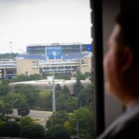 Jimmy looks out the hospital window towards the football stadium.