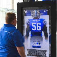 Jimmy interacts with a large screen to design his own Rhoades UK football jersey.