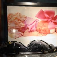 A framed photograph of Julie as a newborn.