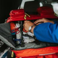 A close-up shot of Matt’s hands as he reaches inside his emergency first aid kit.
