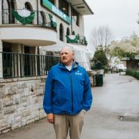 A photo of Matt looking off-camera while standing in front of one of the buildings at Keeneland.