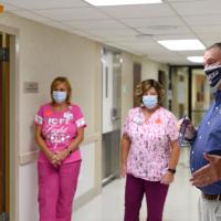 A photo of Michael speaking to Dr. Shanshal and two nurses inside Middlesboro ARH.