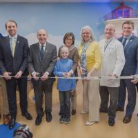 A photo of patients and organizers smiling at the DanceBlue ribbon-cutting ceremony before cutting the ribbon.