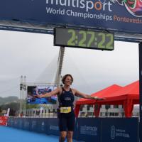 Patty smiles triumphantly as she crosses the finish line at the ITU World Championships in Pontevedra, Spain.