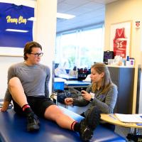 One of Peter’s physical therapists sets up his blood flow restriction, a new therapy that allows him to rehab more effectively.