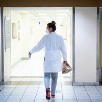 Dr. London-Bounds is walking through the hallway of UK HealthCare, carrying her lunch as she hurries between patients. The camera follows her.