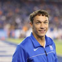 Close up of Travis smiling at a UK football game.