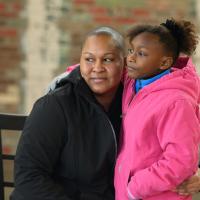 A photo of Whitley and her daughter, Essence Smith, a young African-American girl with curly black hair in a ponytail, looking off camera.