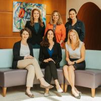 Dr. Lindsay Ragsdale poses alongside five female colleagues inside the lobby of Kentucky Children’s Hospital.