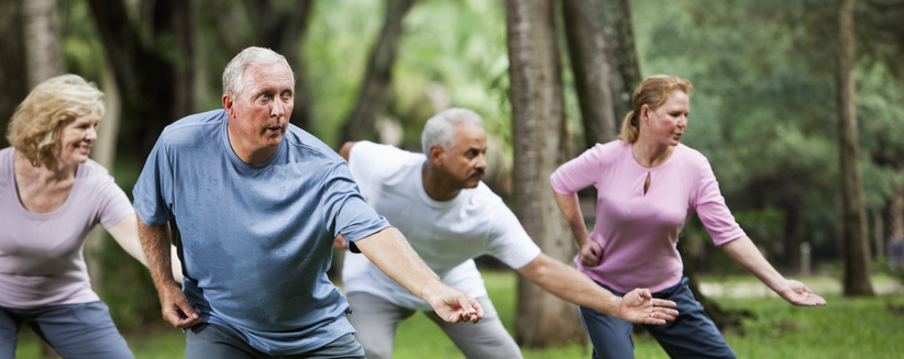 A group of people practice tai chi.