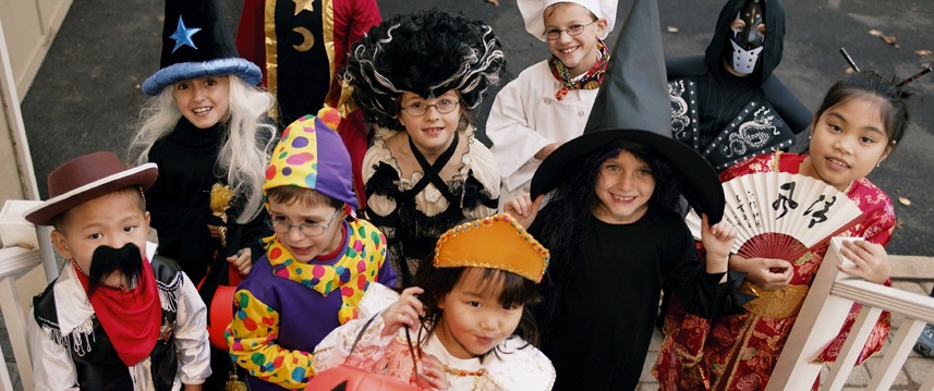 A group of children dressed in Halloween costumes goes trick-or-treating.
