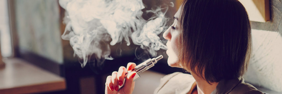 A woman uses an e-cigarette.
