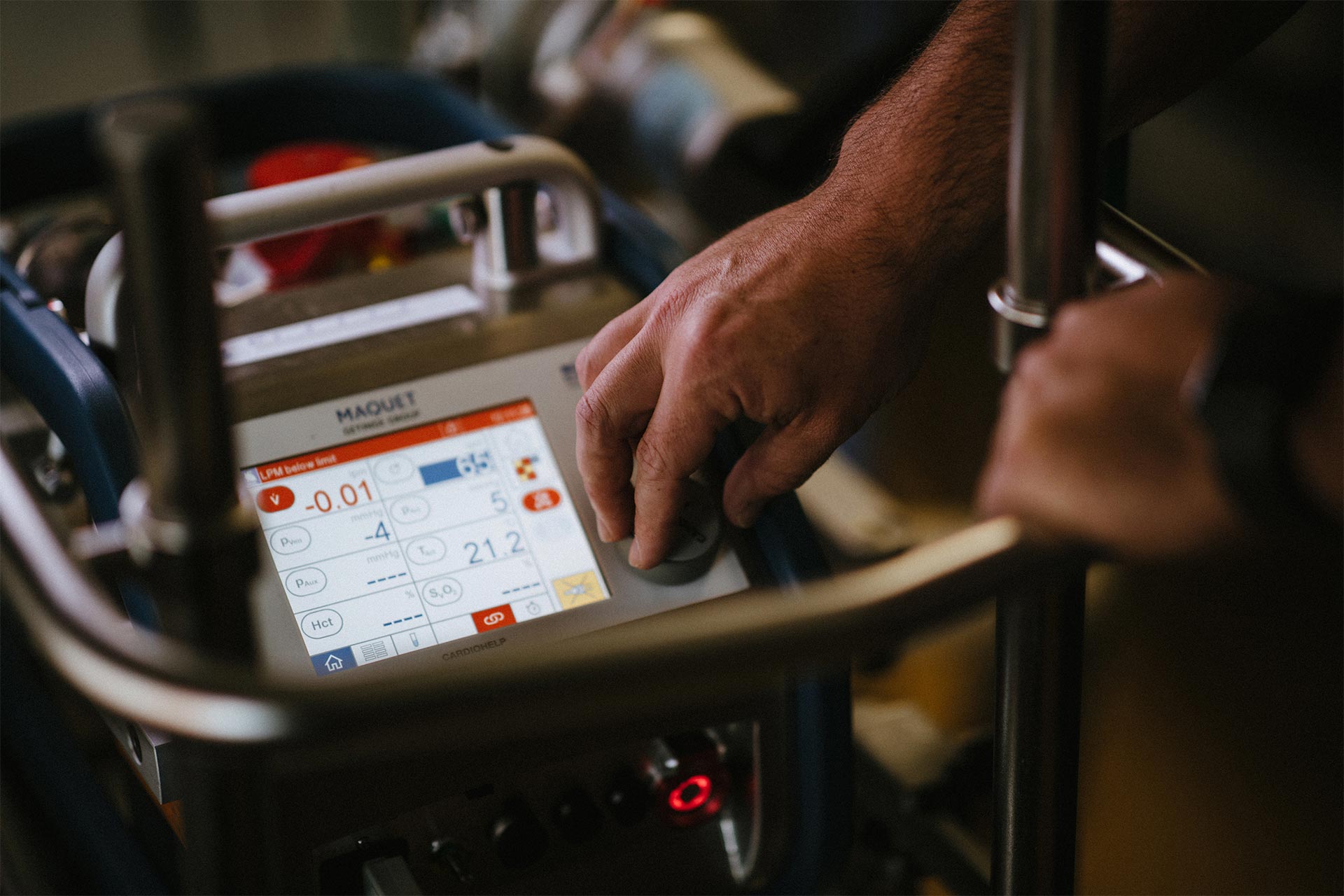 Aaron Harris adjusting settings on an ECMO system