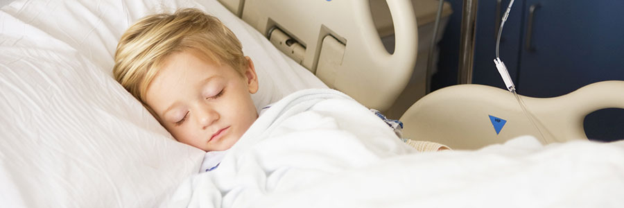 Boy sleeping in hospital bed