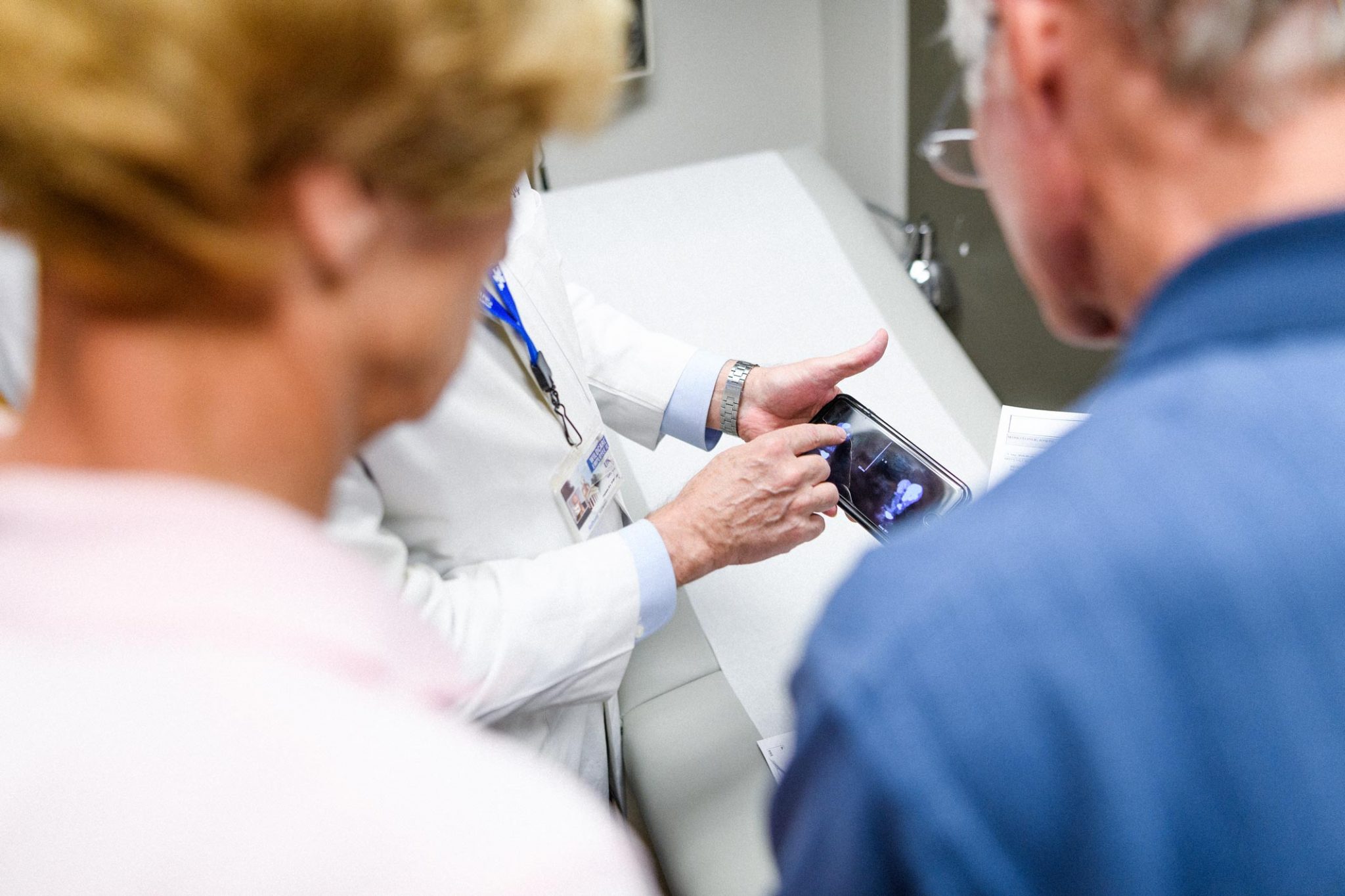 Dr. Lowell Anthony, a specialist at Markey, explains a recent scan to Joe and Cathy.