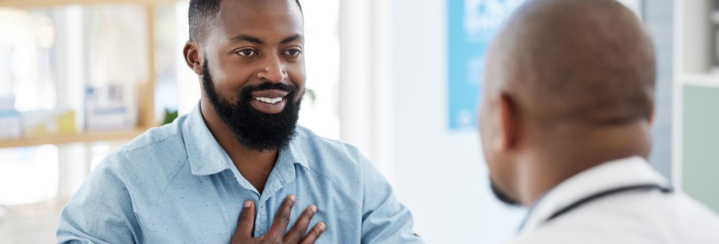 An African-American man speaks with his doctor.