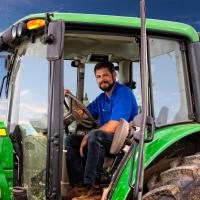 Jacob drives his John Deere tractor.