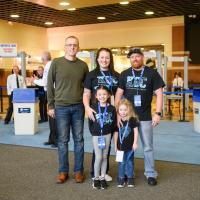 Izzy and her family pose for a photo before entering Rupp Arena for Excite Night.