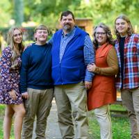 A photo of the entire Mullins family posing together outside at the Ashland estate.