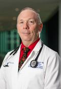 Headshot for Vincent L. Sorrell, MD wearing white coat with stethoscope