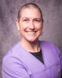 Headshot for Rebecca Todd, MD wearing purple scrubs.