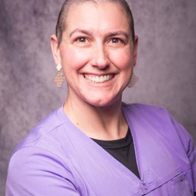Headshot for Rebecca Todd, MD wearing purple scrubs.